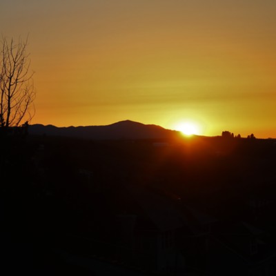 A slice of the sun peeks over the outline of Moscow Mountain as viewed from atop SE Carolstar Drive in Pullman, Washington.  Photo taken by Keith Collins on April 24, 2022.