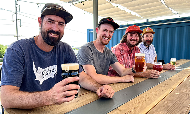 The Fisher Brewing crew, enjoying a round on their newly-built rooftop deck. - MIKE RIEDEL