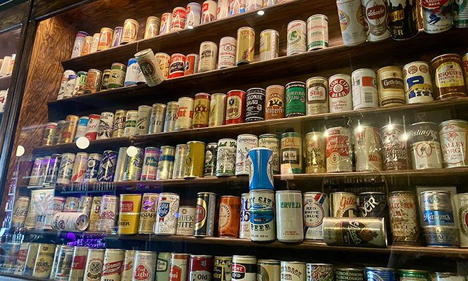 The vintage beer can collection at Junior’s Tavern. - BENJAMIN WOOD